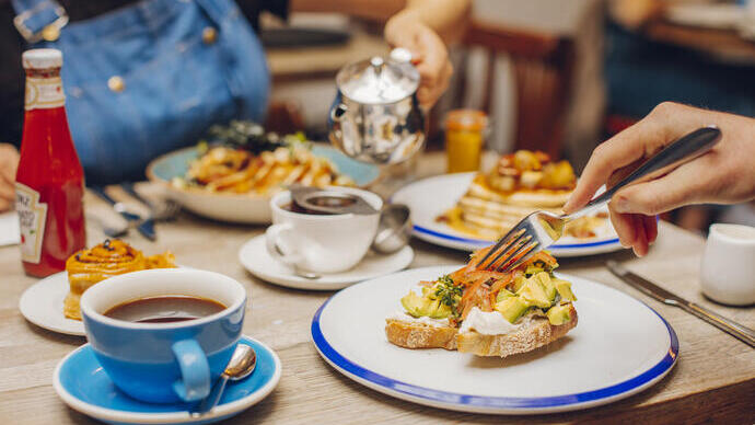 Man and a woman eating food in a restaurant