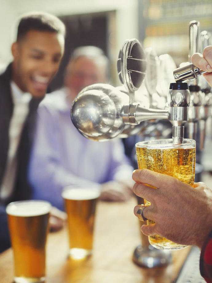Men getting beers for them at a local pub.