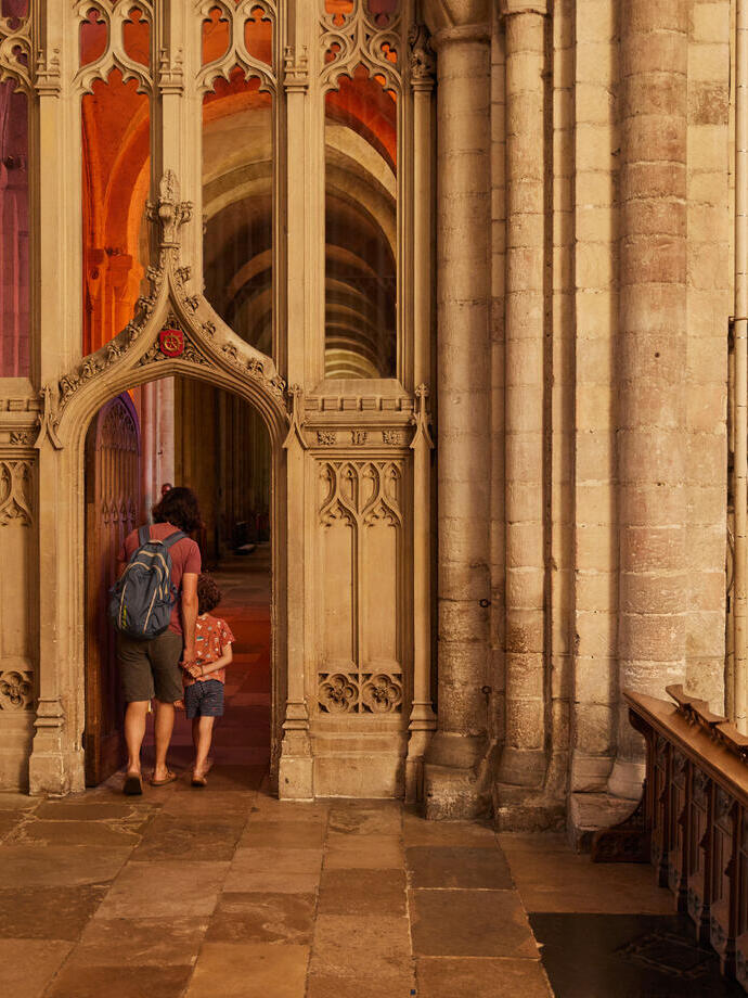 A woman and child exploring the interior of Norwich Cathedral