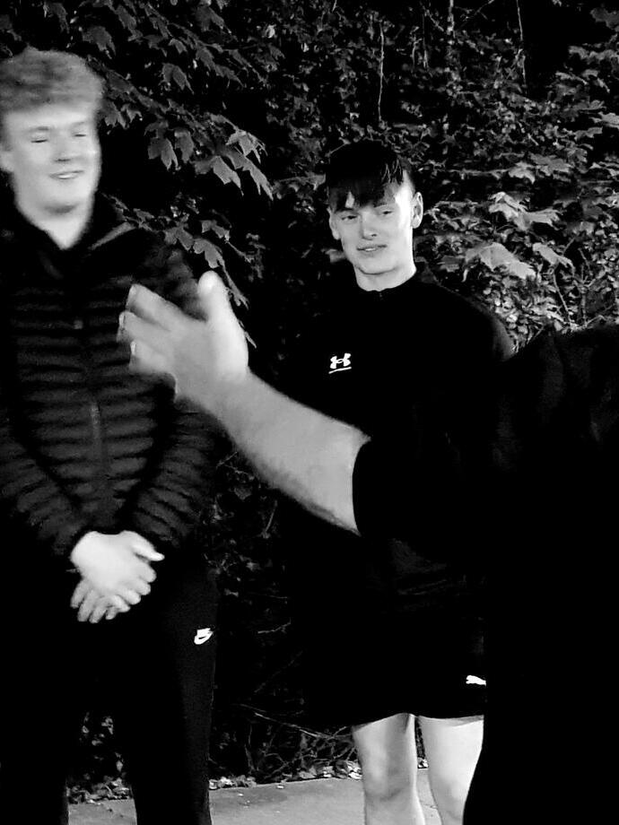 A group of people on a guided ghost walk around the town of Tenby in Wales