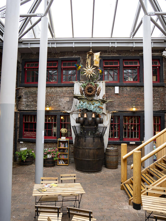Chairs, tables and a sculpture at an internal courtyard