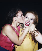 Two women smiling and hugging