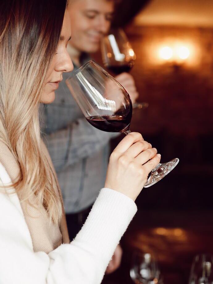 A man and woman wine tasting