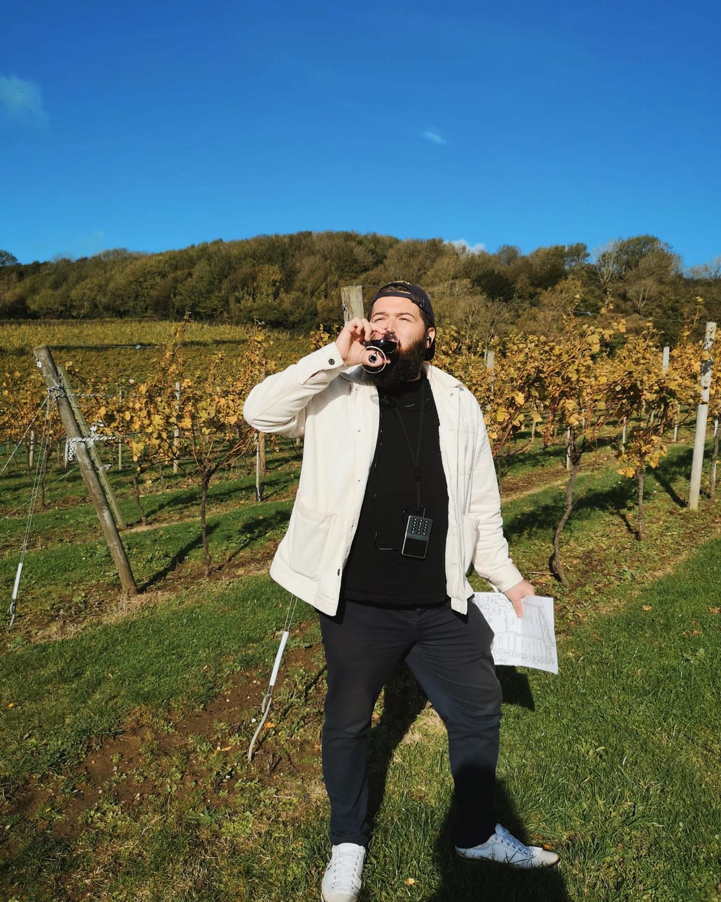 A man enjoying a drink at Adgestone Vineyard