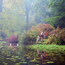 Two men on the swimming platform of a lake in an autumnal setting