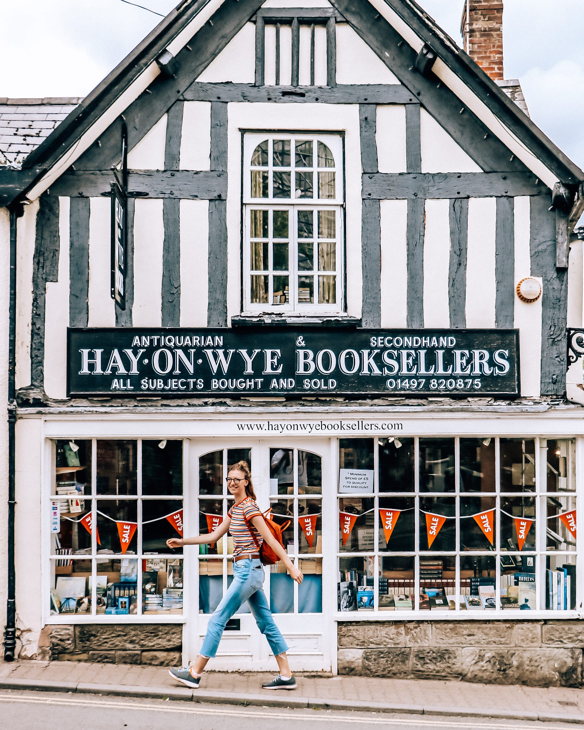 Woman walking past a bookshop