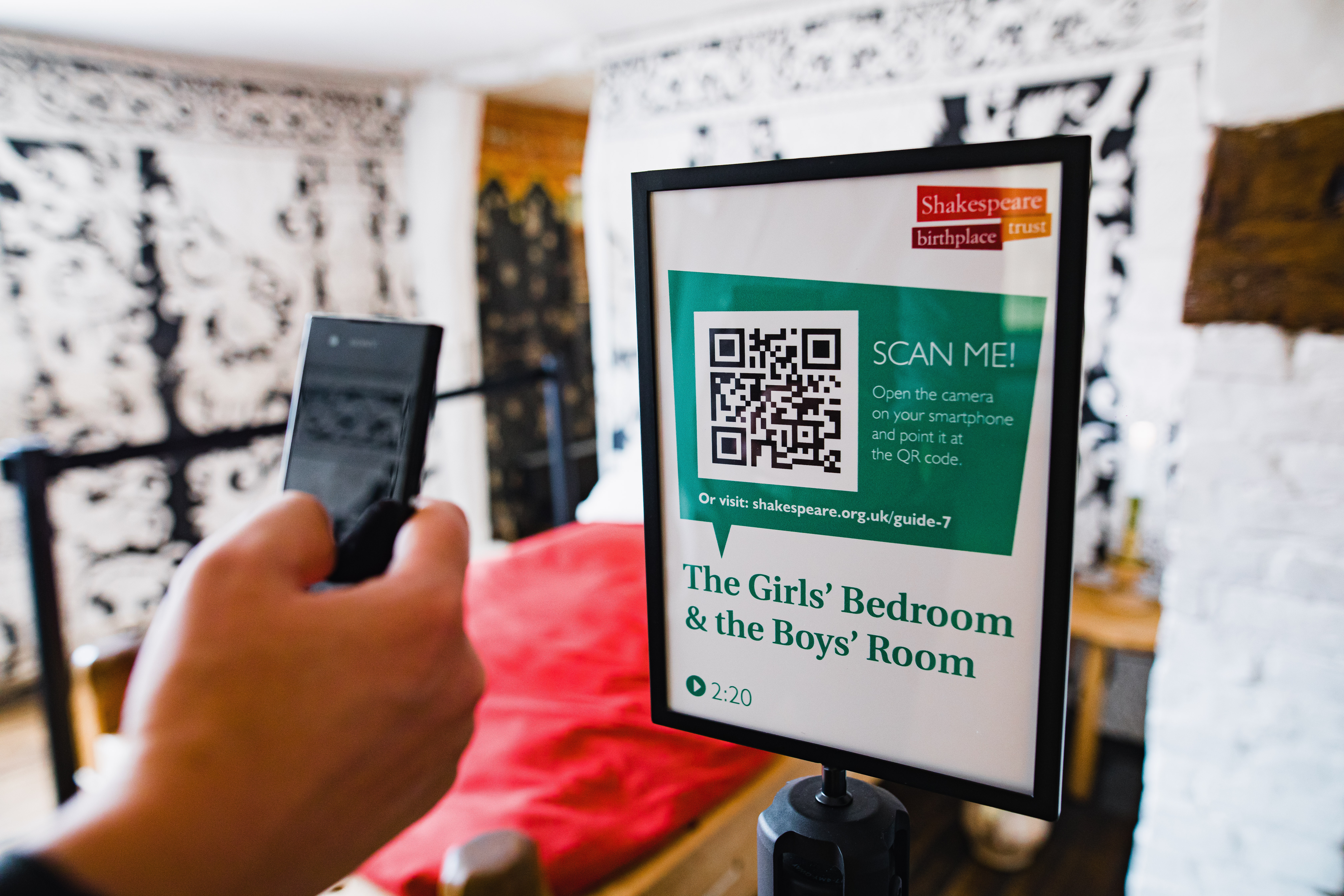 Close up of a hand scanning a QR code with a smart phone at the Shakespeare Birthplace Trust