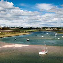 Sailboats moored on the a river at the edge of the North Sea