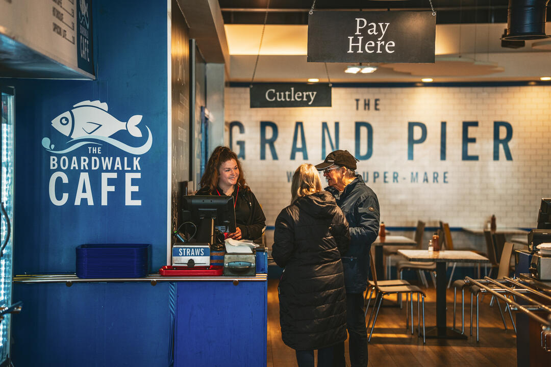 Cafe interior with cashier and two patrons