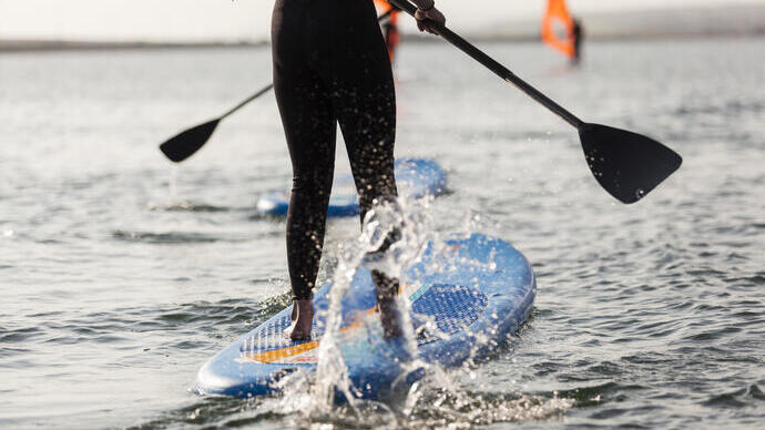 Woman standing on a paddle board in the sea