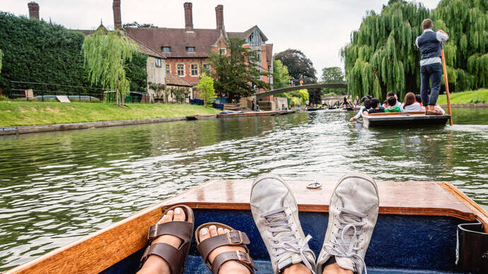 Two feet inside a boat; punting on a river