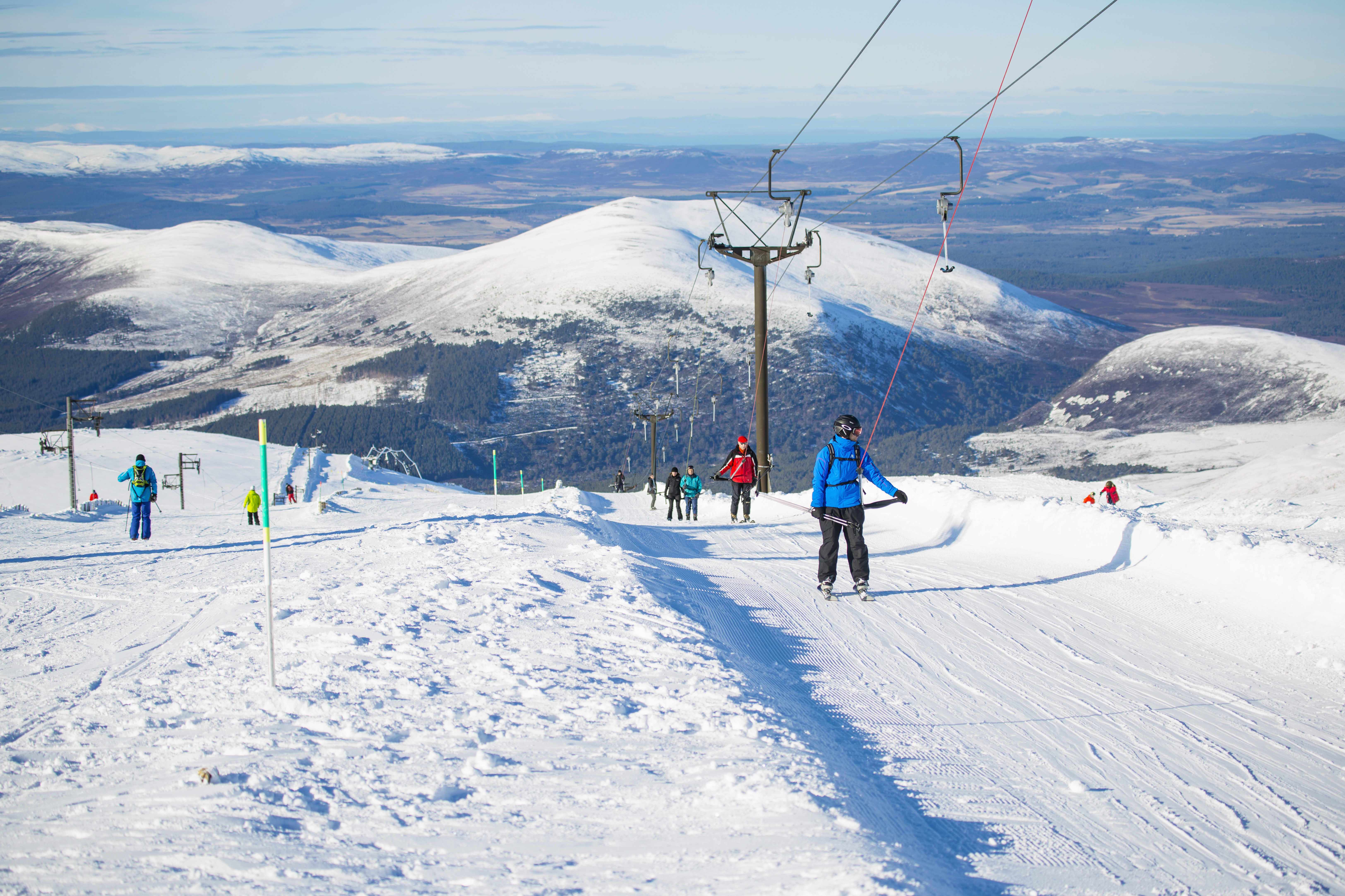 Group of skiers on a snowy slope in the Cairngorms National Park, Scotland