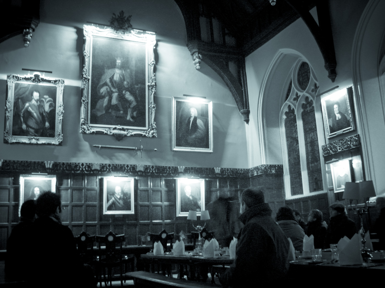 People sat in a historic hall on a ghost tour of Oxford