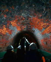 A tour group being guided through a tunnel underneath Dudley Canal