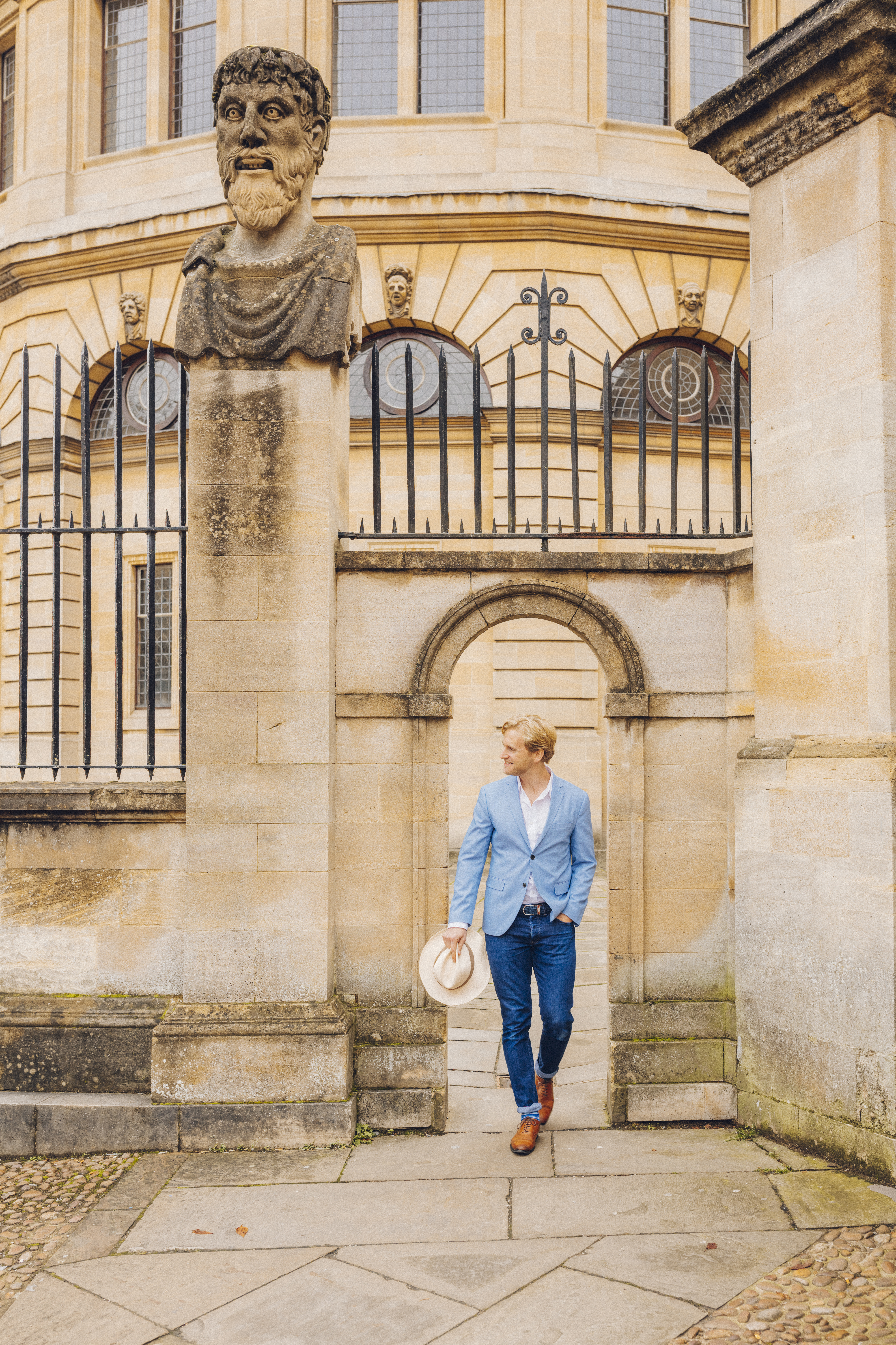 Man walking through a sandstone archway