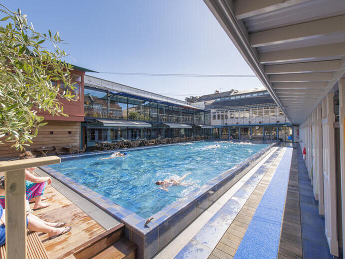 People swimming in an outdoor pool at Bristol Lido