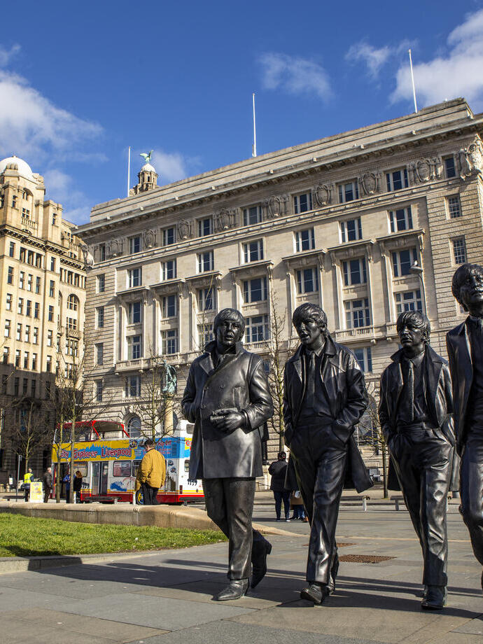 Beatles statue in a city centre.