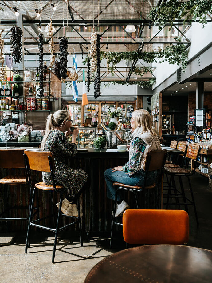 Two women having a drink at a bar