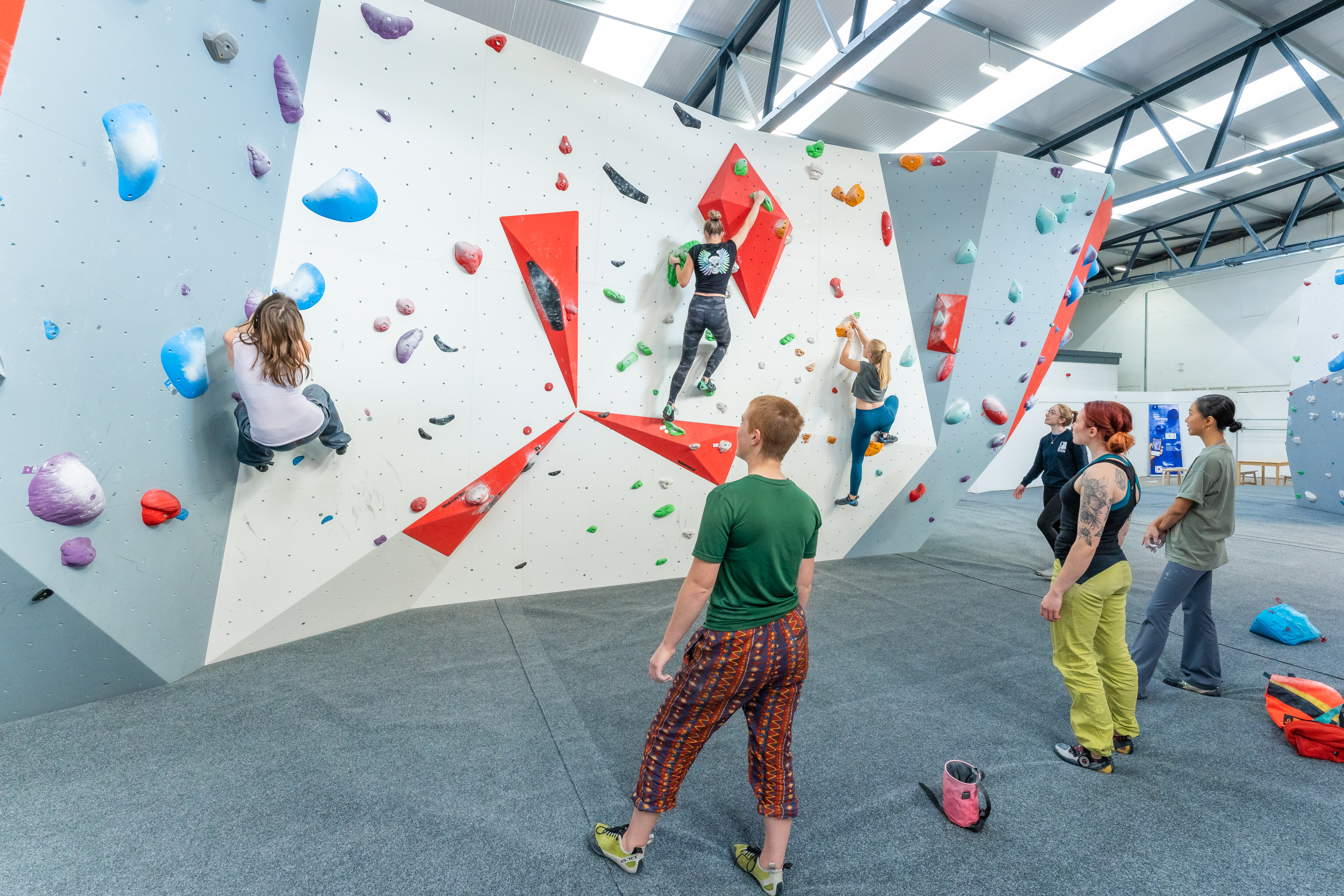 People climbing an indoor bouldering wall in Lancashire