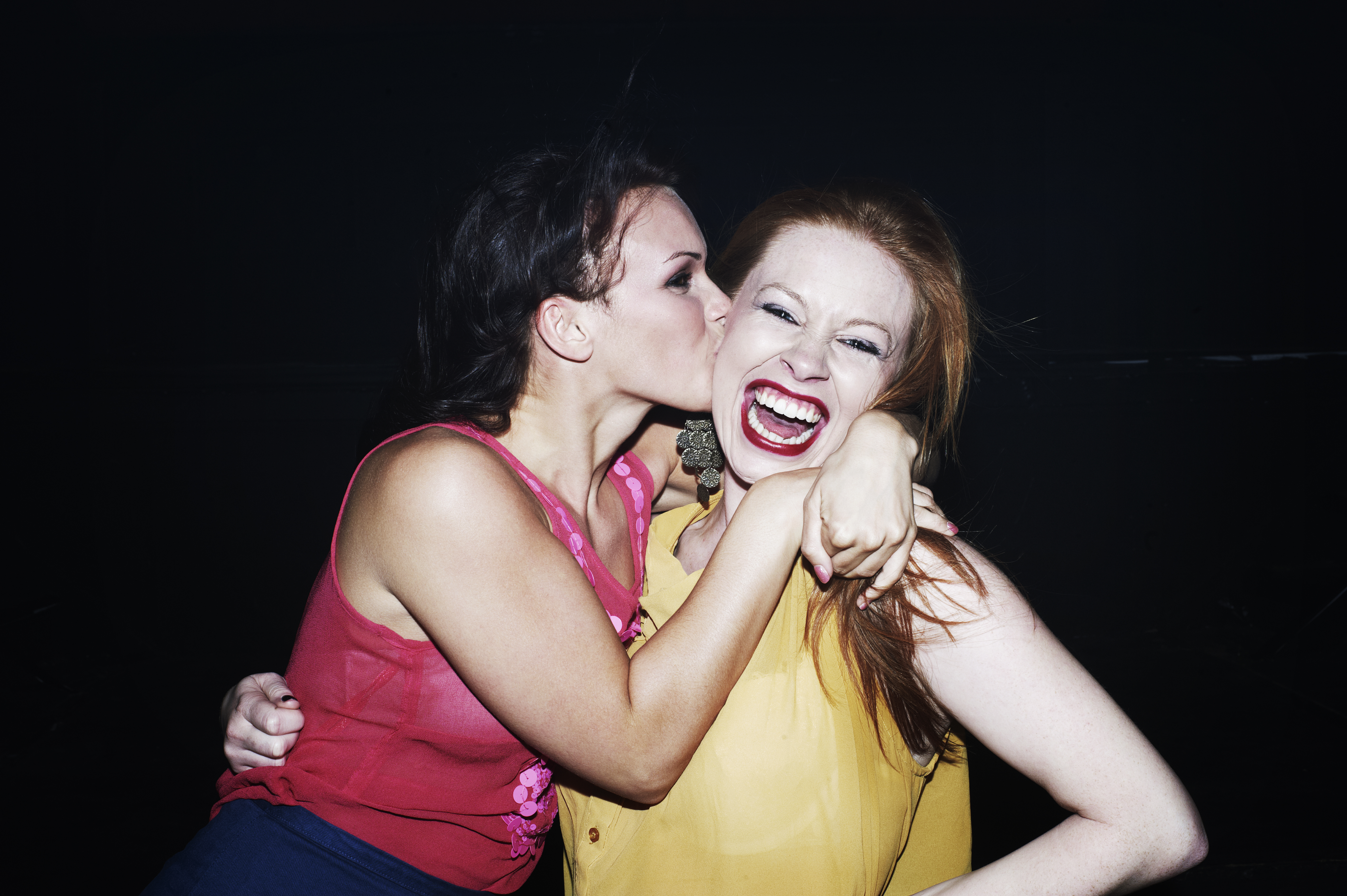 Two women smiling and hugging