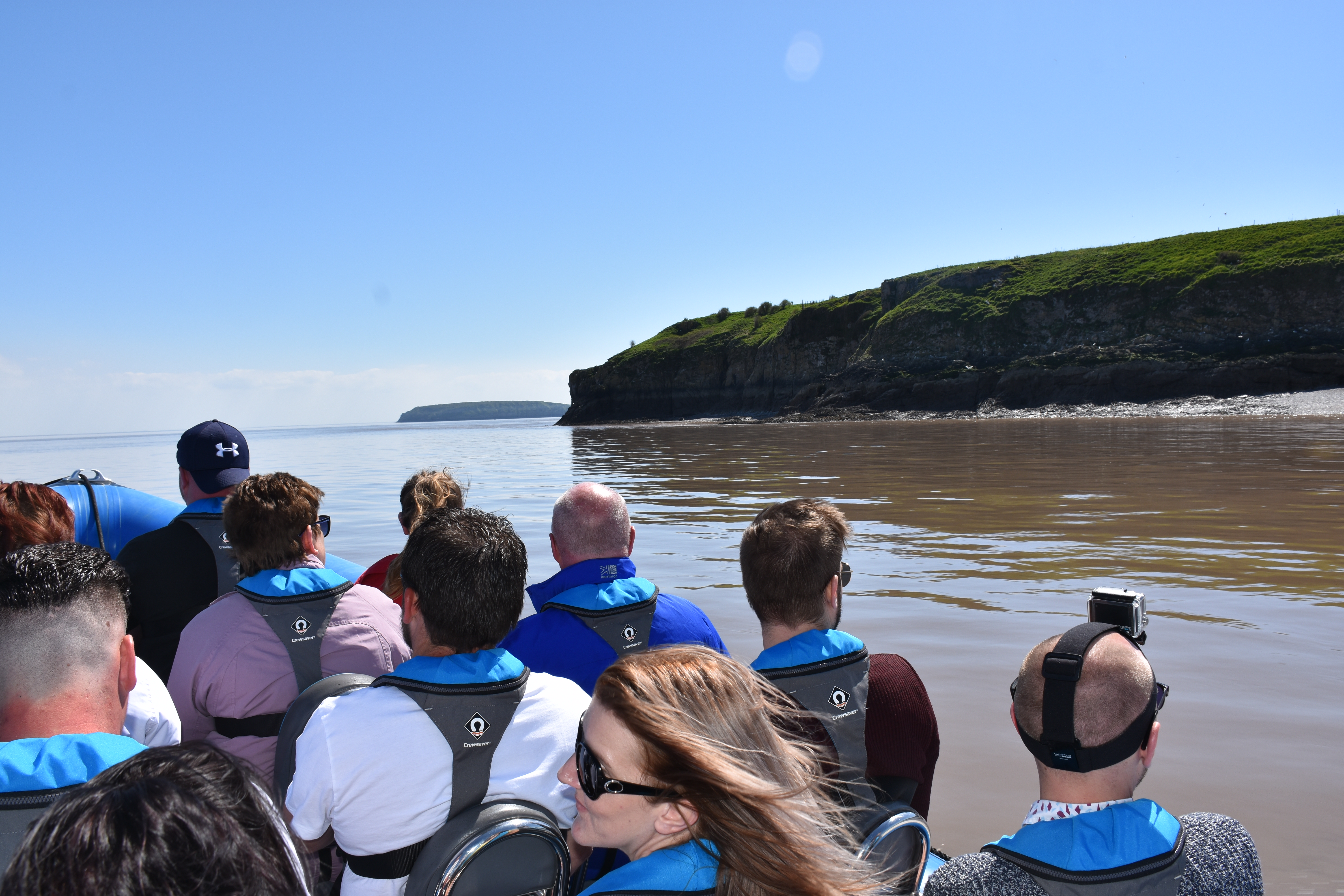 A group of people on a boat tour around Cardiff's bay area