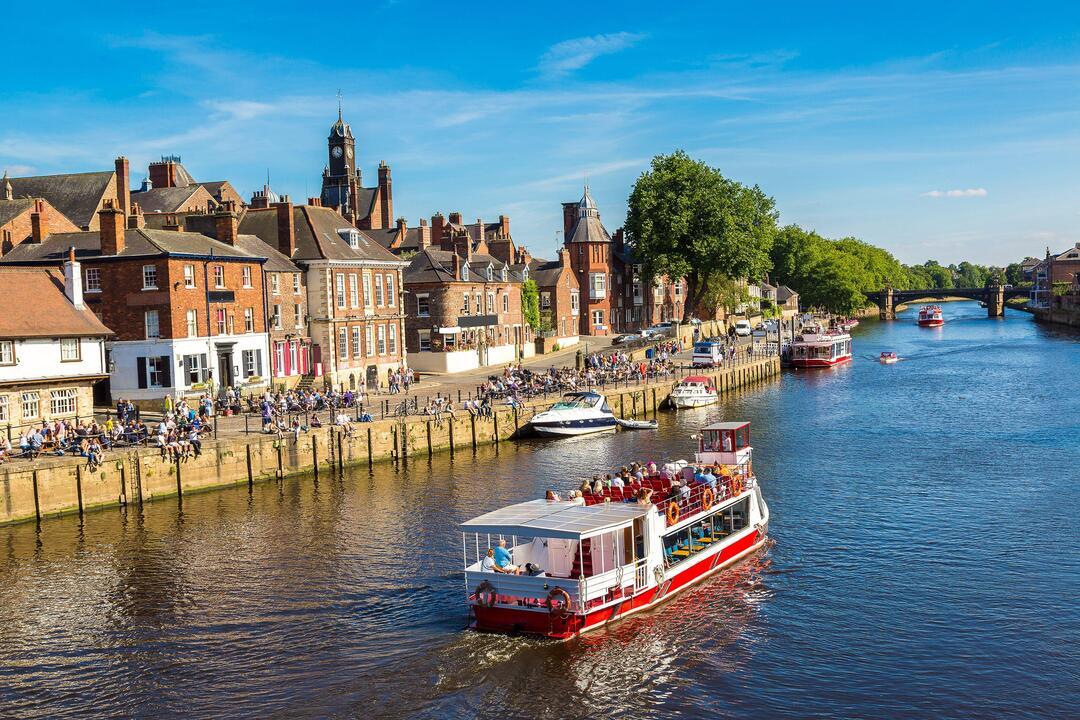 A cruise ship travelling down the River Ouse in York