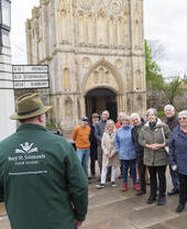 A tour group gathered outside of Bury St Edmunds Abbey.
