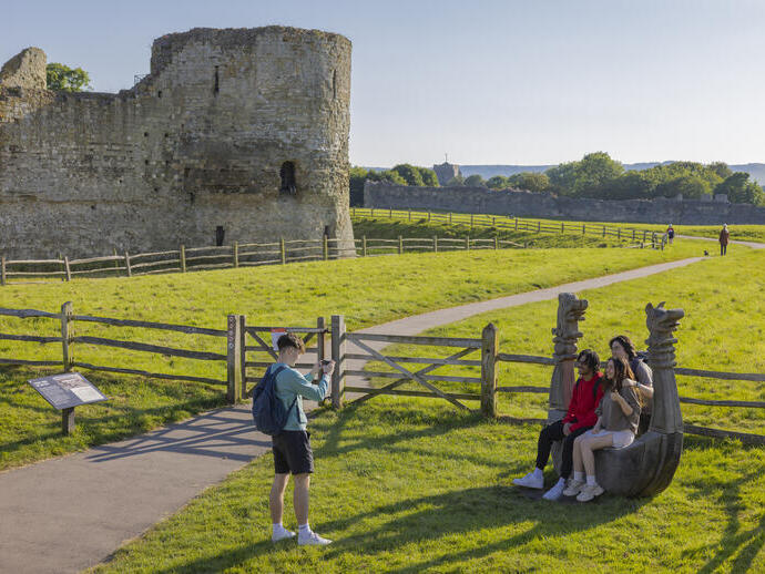 A group of friends visit castle ruins in the summer