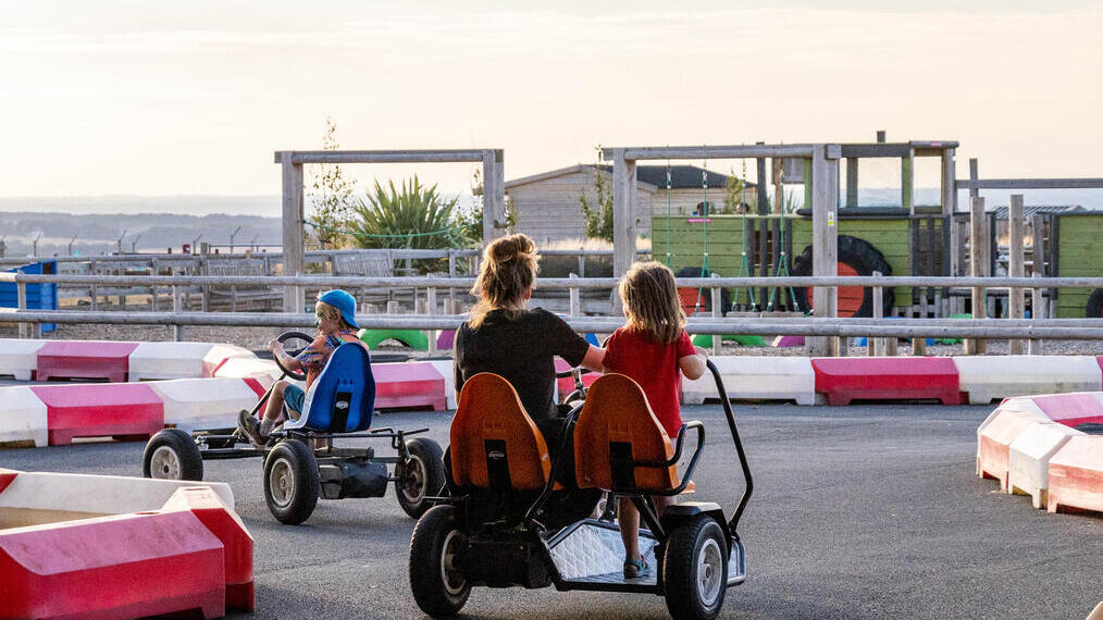 People racing in pedal go-karts