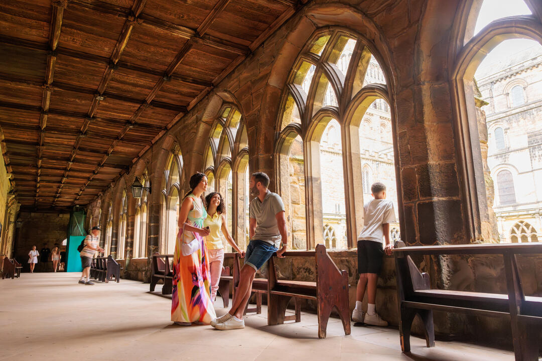 A family share a moment inside the cloisters of a cathedral