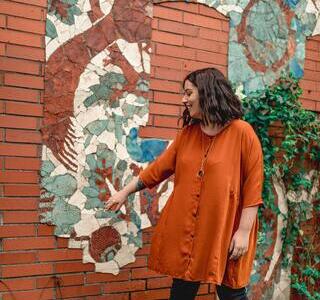 Standing infront of a mural