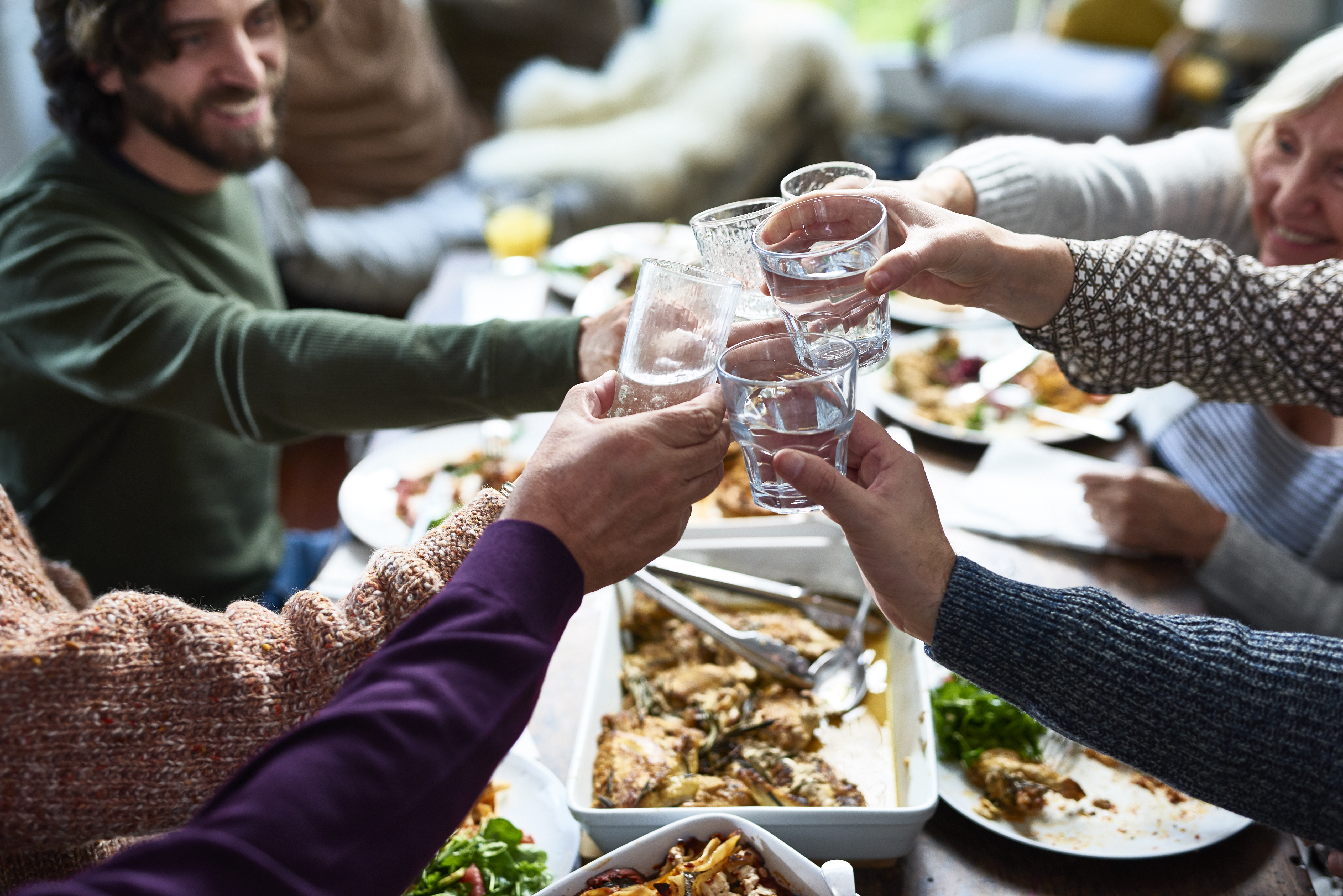 A group of people toasting drinks at a lunch