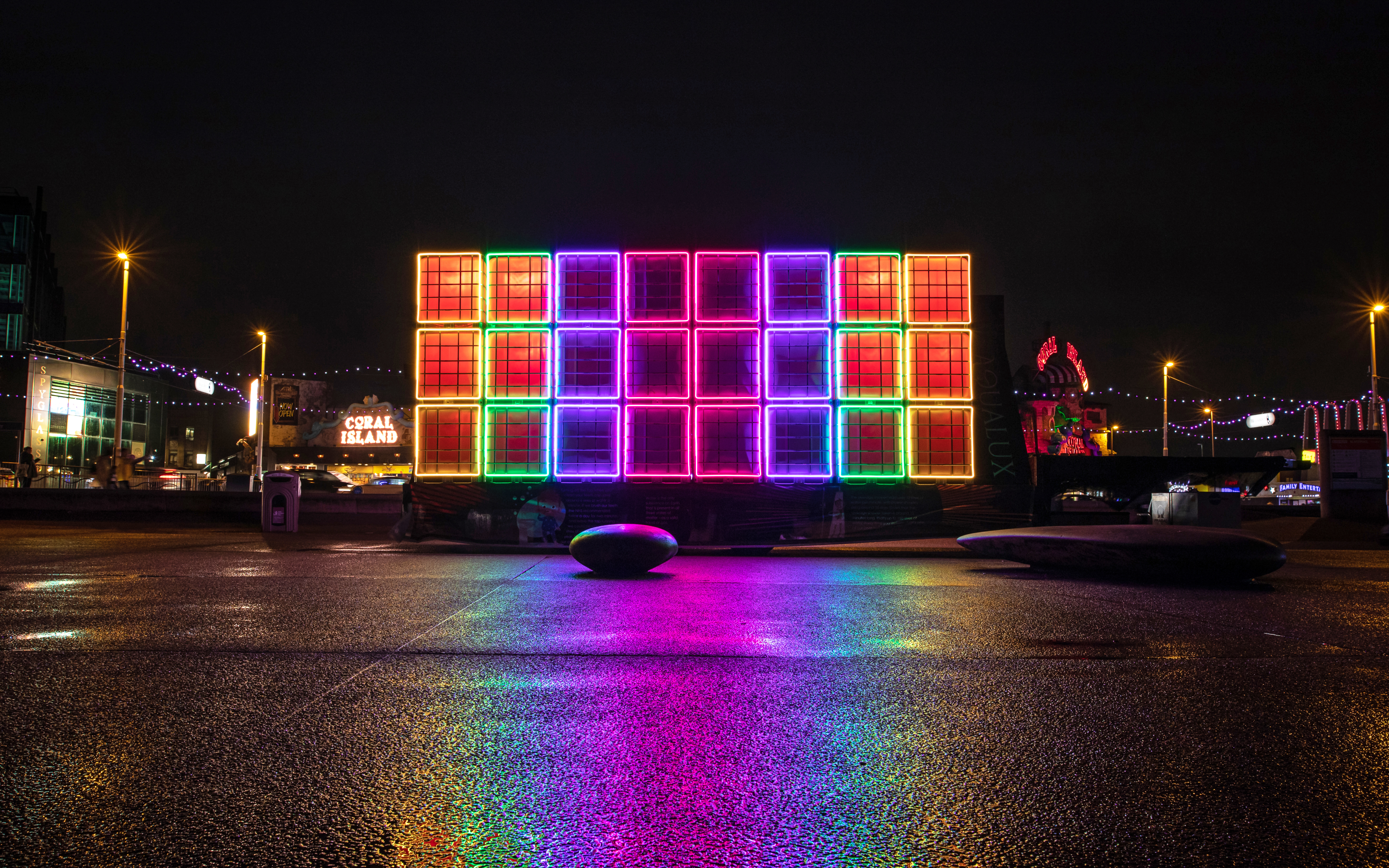 A colourful light installation at night.