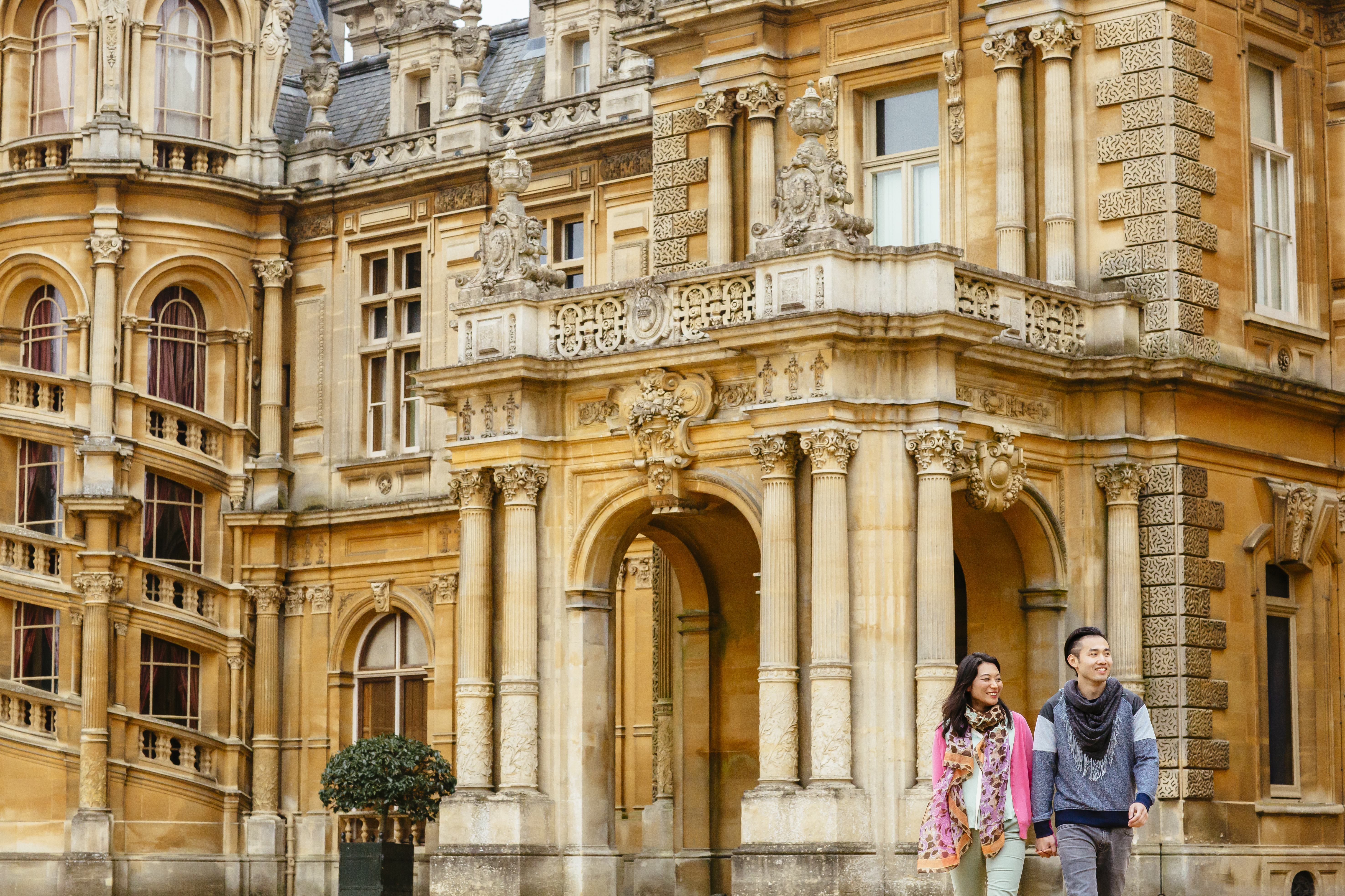 Couple walking outside a stately home