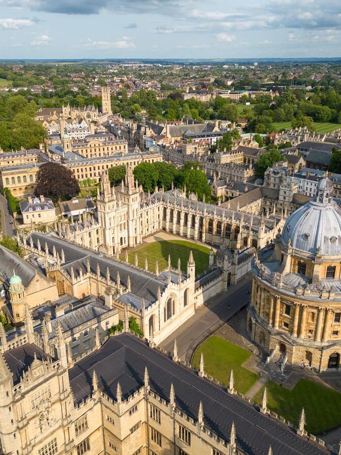 Aerial view of university featuring large dome and historic stone buildings 