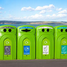 Row of recycling bins overlooking the coast