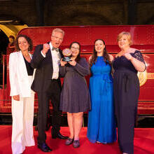 Photo of Gold Award Winners for the Accessible & Inclusive Tourism Award at the VisitEngland Awards for Excellence 2023 - Noah's Ark Zoo Farm (Representatives from Noah's Ark Zoo Farm, VisitEngland Director of HR and Professional Services Debra Lang, Relationship Director for Hospitality & Leisure at Corporate Banking Barclays Andy Mayne, Compere Alex Polizzi) - in front of the Hogwarts Express on stage