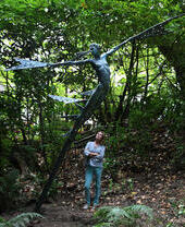 Artist with sculpture Theia Goddess of light at The Sculpture Park