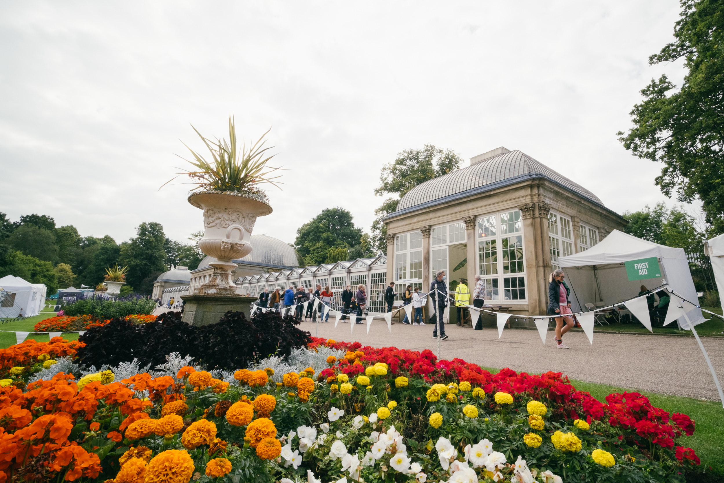Groups of people exploring the art installations in Sheffield Botanical Gardens
