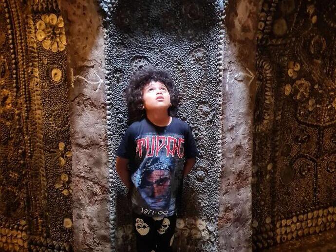 A boy in Shell Grotto