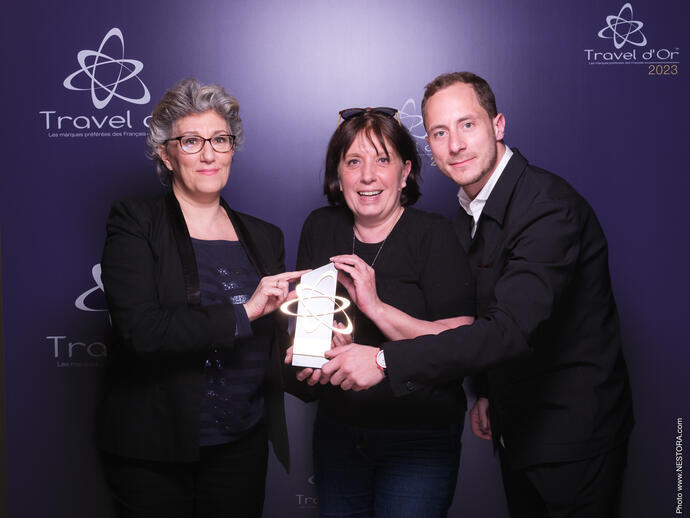 Three people holding an award at Travel dOr 2023
