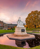 View of the garden at Kensington Palace including statue and pond