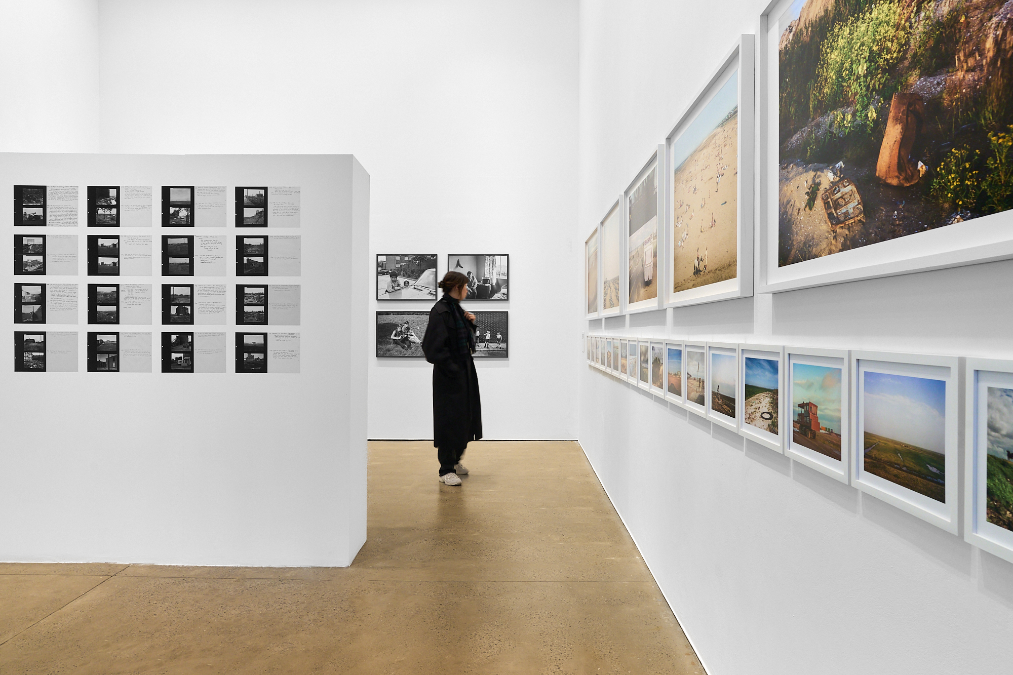 A woman admiring work at a photography exhibition.
