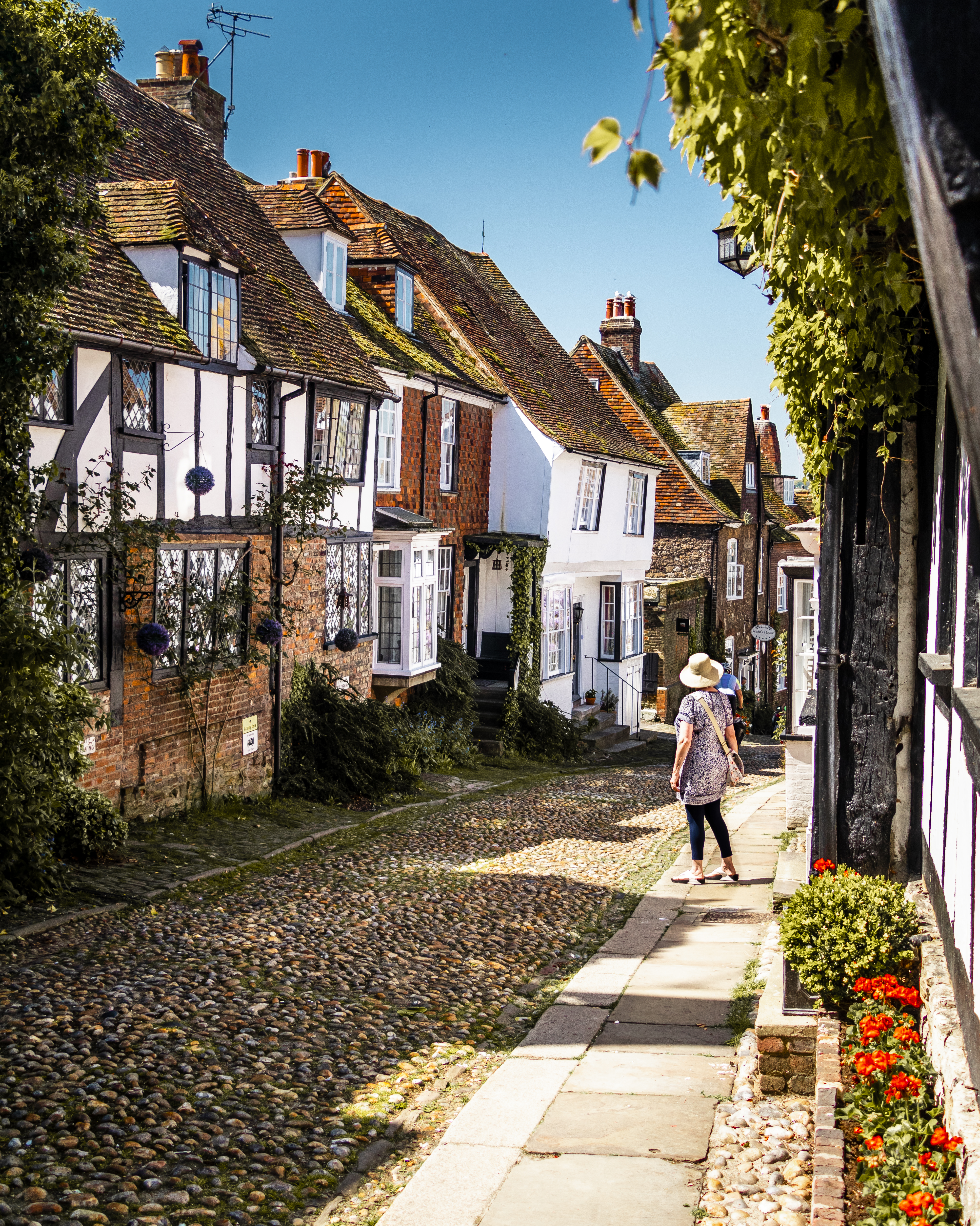 Woman looking down a narrow village street 