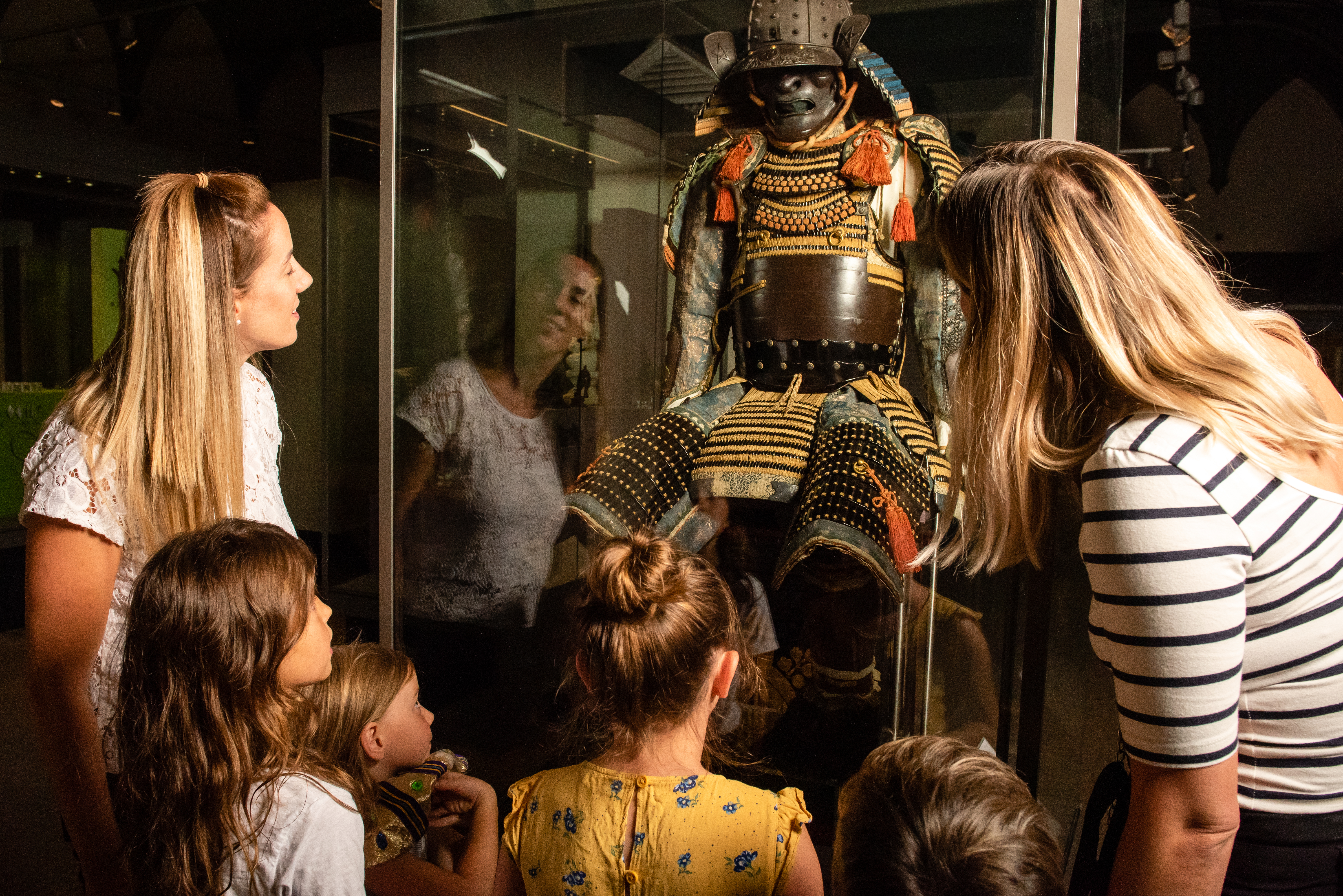 A group of people looking at a historic exhibition