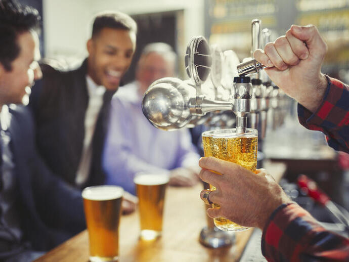 Men getting beers for them at a local pub.