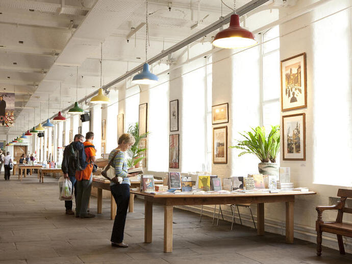 People browsing books and artwork at a gift shop