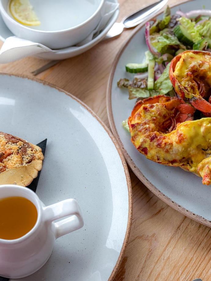 Plates of seafood dishes including lobster.