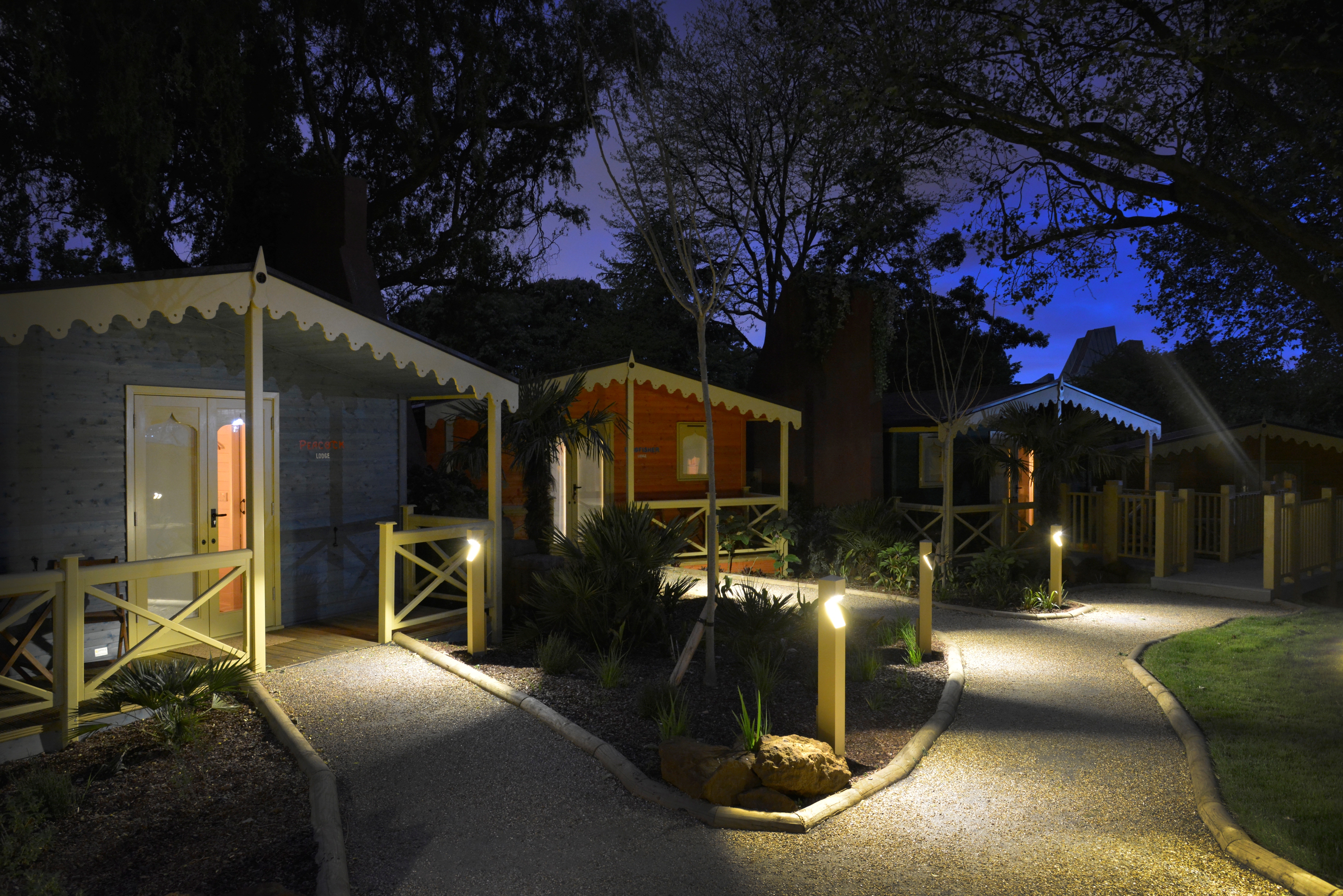 Wooden accommodation lodges set in a row at a zoo