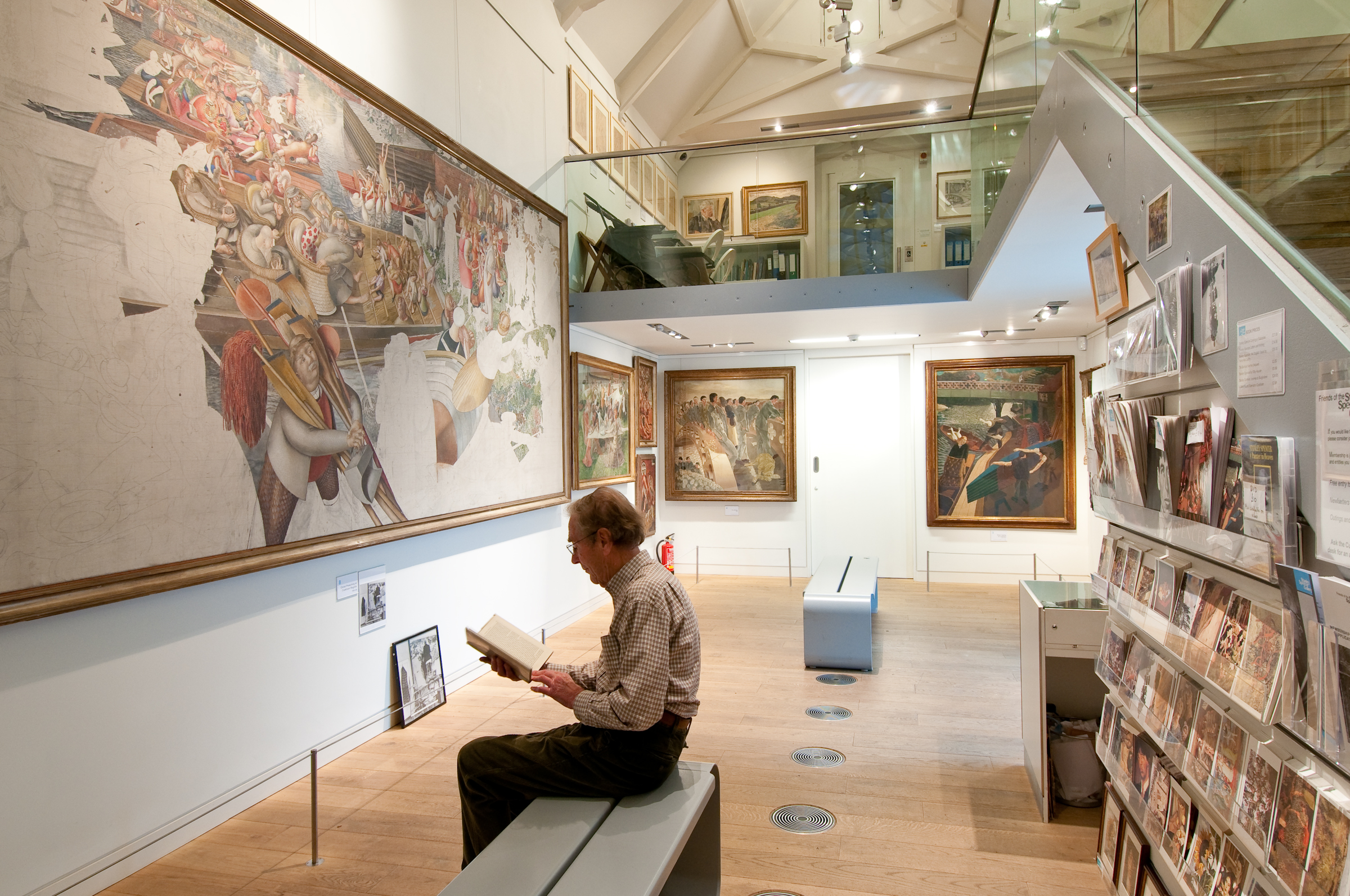 A man reading a book in the Stanley Spencer Gallery in Windsor